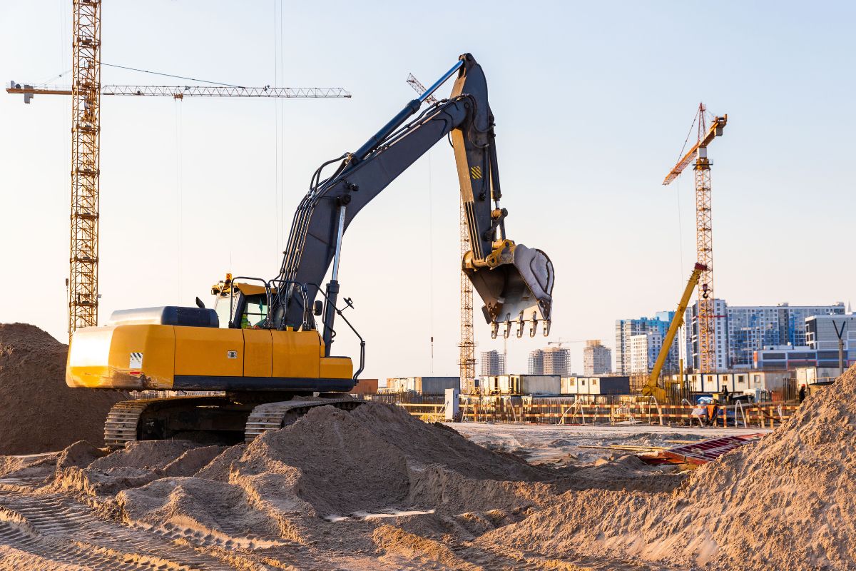 Managing a construction site featuring cranes and diggers